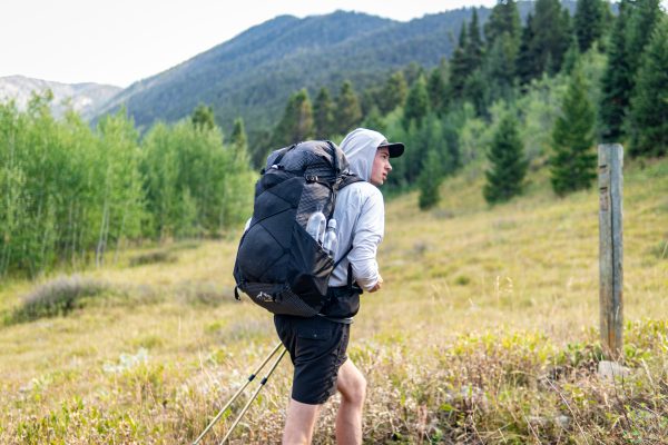 A hiker wears a black robic circuit in the wilderness.