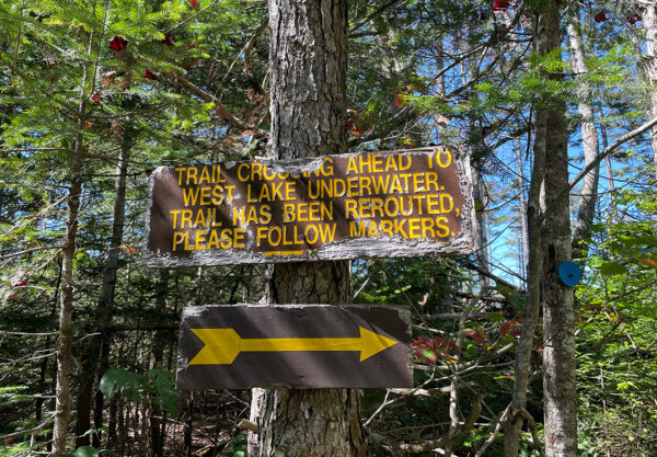 A trail sign directing hikers to a re-route