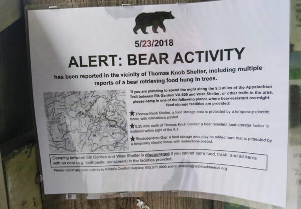 A sign telling hikers about bear activity is shown along the Appalachian Trail
