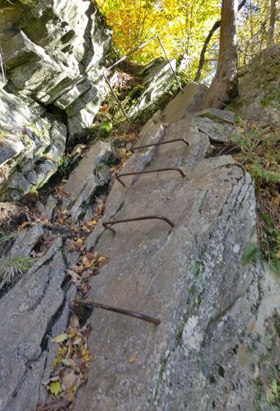 A metal ladder works it's way up a rock face