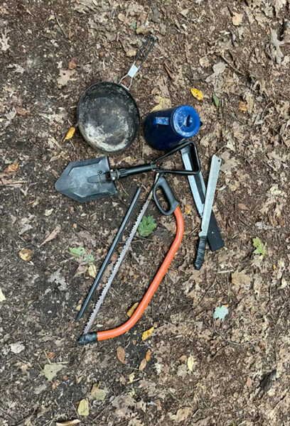 A collection of discarded trail tools and gear collected during a trail clean up.