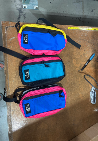 Three brightly colored Entropy Spare Tire's sit finished on the shop counter.