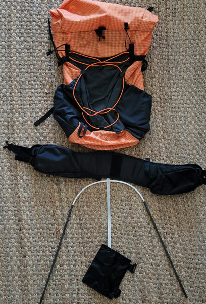 A ULA pack with the hip belt, accessories, and hoop removed so it is ready to wash.