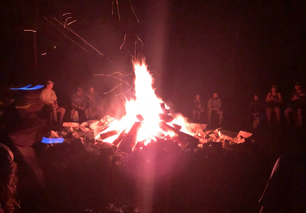 Appalachian Trail through hikers sit around a bonfire.