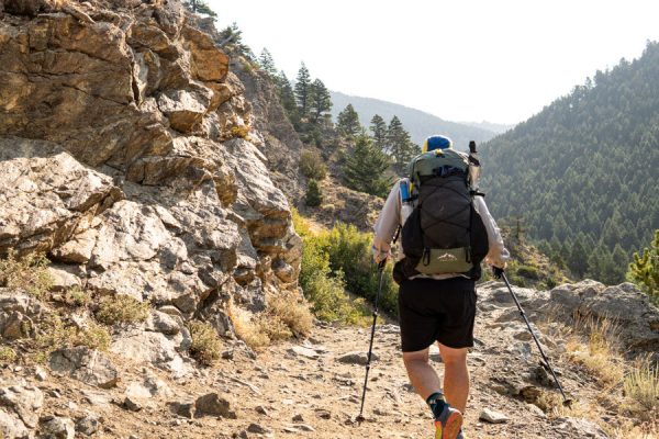 Robic Circuit SV fully loaded on a backpacker who is hiking through rocky terrain.