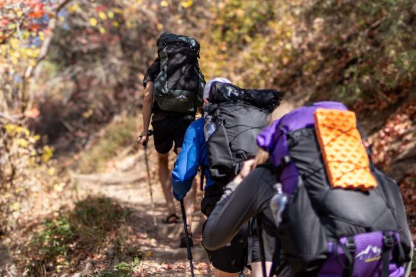 Three friends hike up a hill wearing their Robic Circuit SVs.