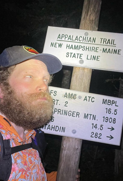 Professor Carl at the New Hampshire/Maine State line on the Appalachian Trail. He has arrived in the dark.