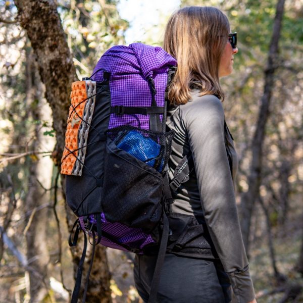 A side view of a female hiker in a purple Circuit SV