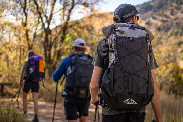 Three hikers wearing Circuit SVs on the trail.