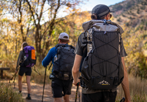 Three hikers out testing gear: Owen is closest to the camera wearing his Circuit SV