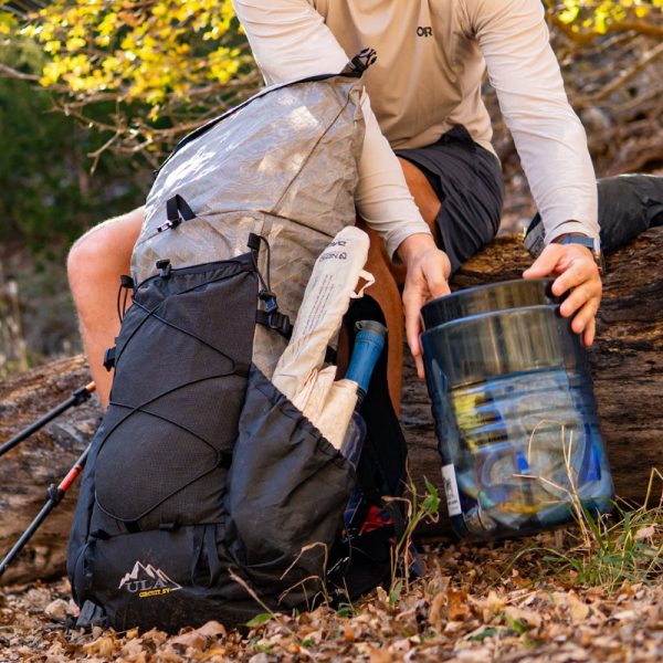 A hiker removes their bear bin from the ULTRA Circuit SV.