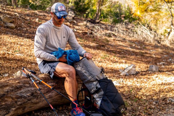 An Ultralight backpacker removes a jacket from the Ultra Circuit SV
