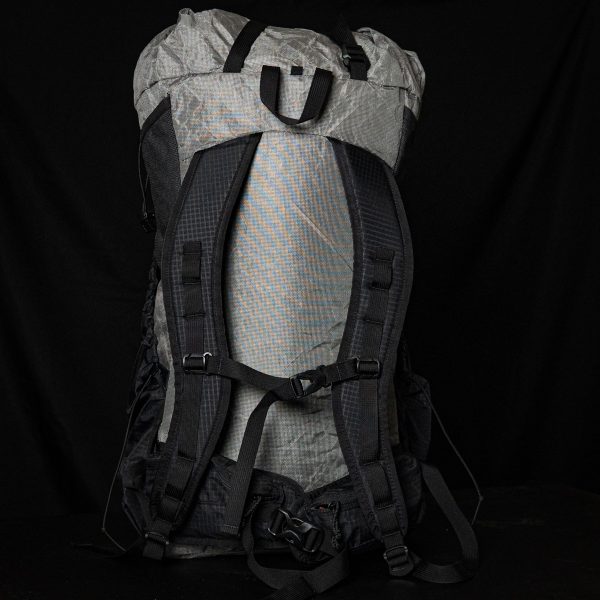 A back view of a Nexus showing the shoulder straps and hipbelt. The background is black.
