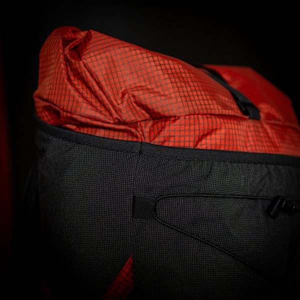 A detailed view of the roll-top collar on the ULA Nexus backpack.
