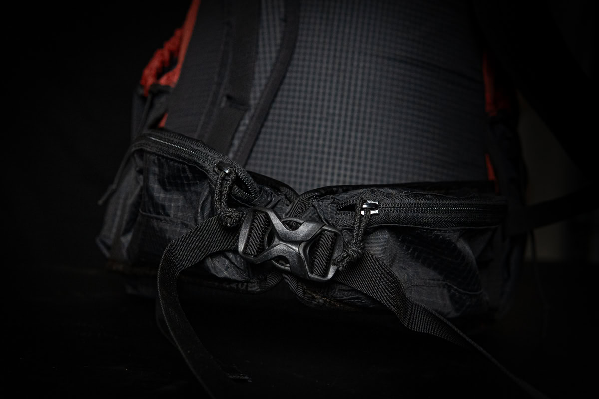nexus tease 3-15 Backpacker reaches for his bear spray from the ULA Deploy Bear Canister Holder on his shoulder strap.