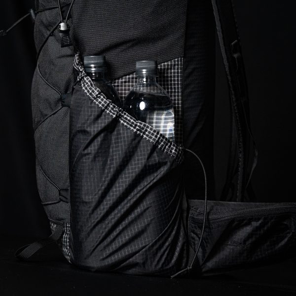 A Nexus side pocket with two Smartwater bottles in it, side by side.