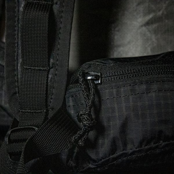 A close up of the zipper on the hipbelt pockets of the Nexus