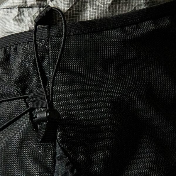 The top trekking pole cinch straps on a the Nexus backpack.