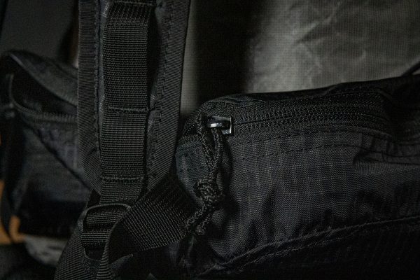 A close up of the zipper on the hipbelt pockets of the Nexus