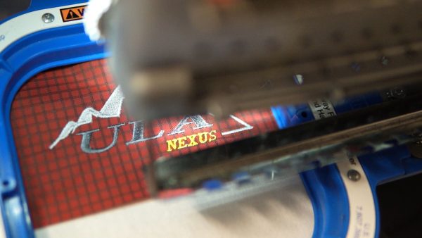 The ULA embroidery machine adding the embroidered logo to the bottom panel of a ULA Nexus pack