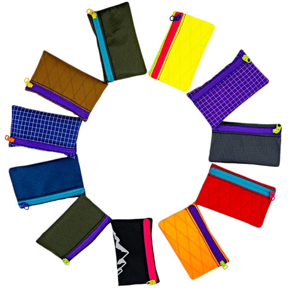 ULA trail wallets in wide selection of colors. There are 12 in a circle and they are all very different and brightly colored.