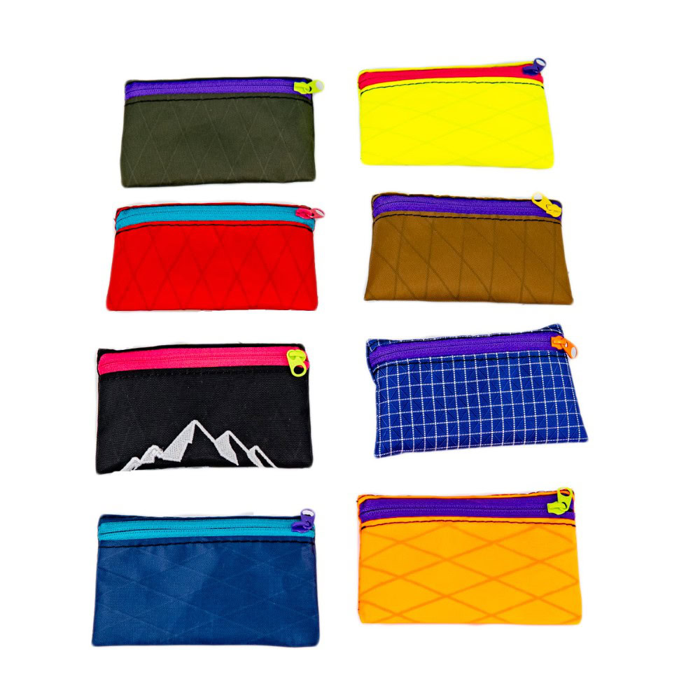 ULA trail wallets in wide selection of colors. There are eight pictured and they are all very different and brightly colored.