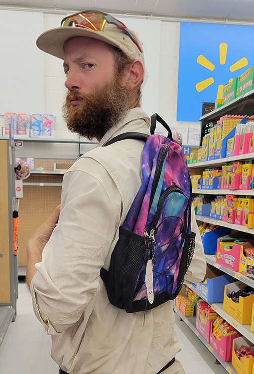 A BearVault being opened by a hiker. The BearVault also keeps your snacks from getting crushed.