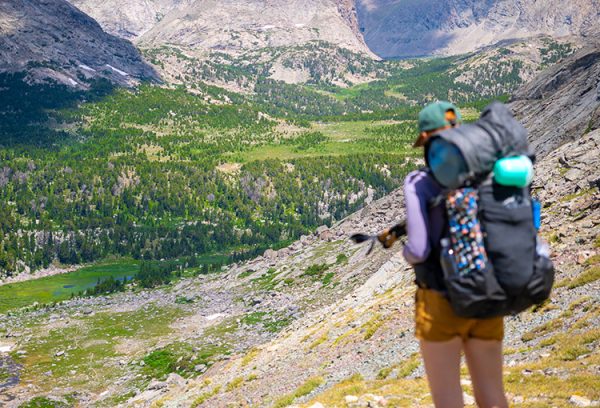 A female backpacker carries her backpack through the Wind River Range in Wyomming