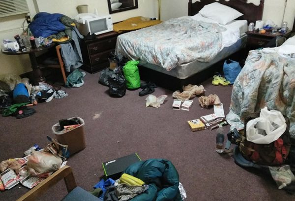 Through hikers share a hotel room to save money. In typical through hiker fashion the room looks like they are having a garage sale.