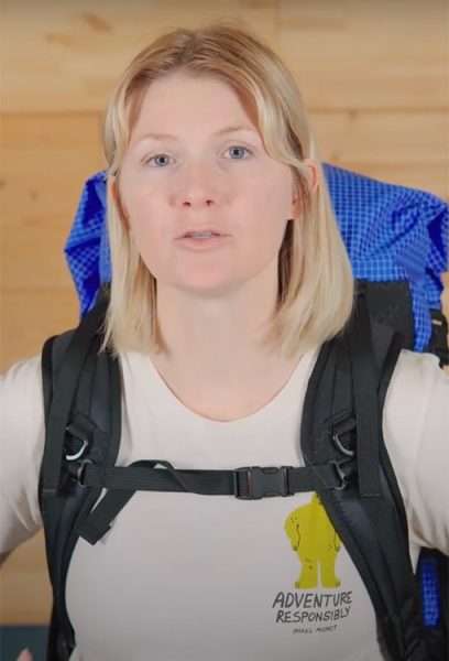 Image shows a female in a pack with S-strap shoulder straps.