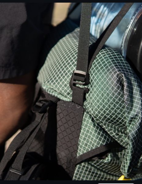 A close up of the "g-hook" that connects the Y-straps and bottom straps to the loops on the backpack.
