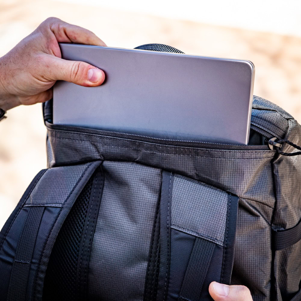 Dragonfly 36L Laptop pocket, with laptop sticking out.