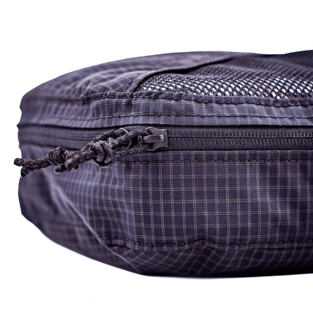 A detailed view of the ULA Packing Cubes Zipper showing the easy grip pull tabs, which are cord.