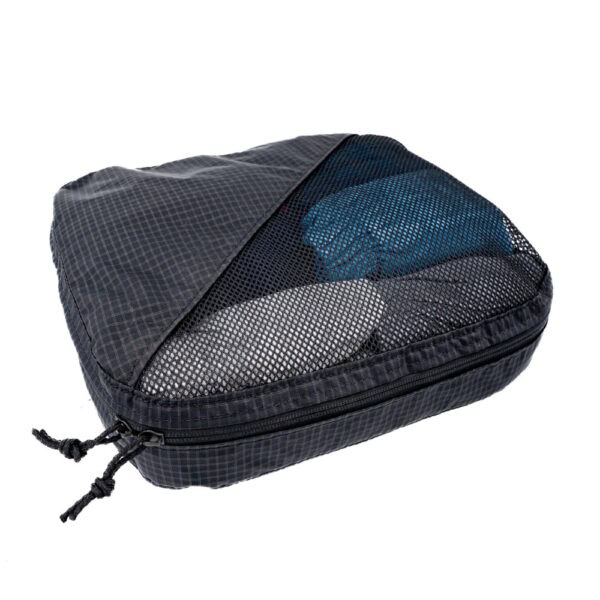 A large ULA Packing Cube Packed and Zipped. The front is half mesh, so you can see what is inside.