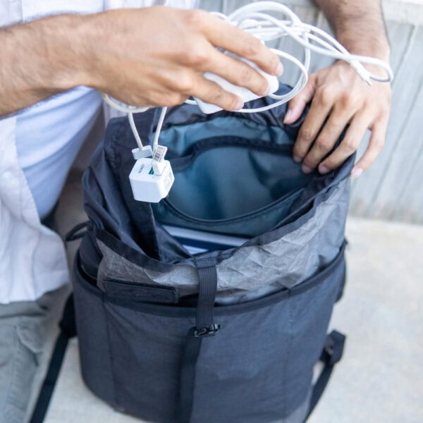 Urban explorer adds charging cord to small zippered Packrat pocket for safe keeping