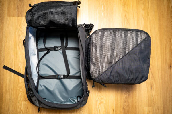 An open ULA Dragonfly with a fully packed ULA packing cube sitting next to it to show how they are a compatible size.