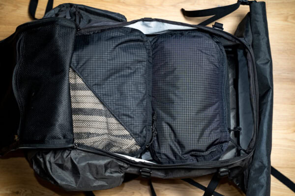 An open 36L ULA Dragonfly with a bundle of fully packed ULA packing cubes (2 large and 1 shoe cube) inside it to show how they are a perfect fit.