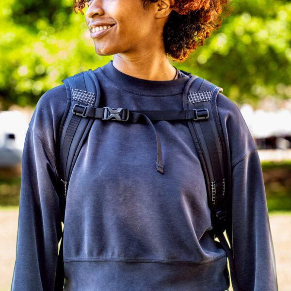 Student wears a black robic ULA Packrat Daypack, image from front showing comfortable straps and sternum strap in use.