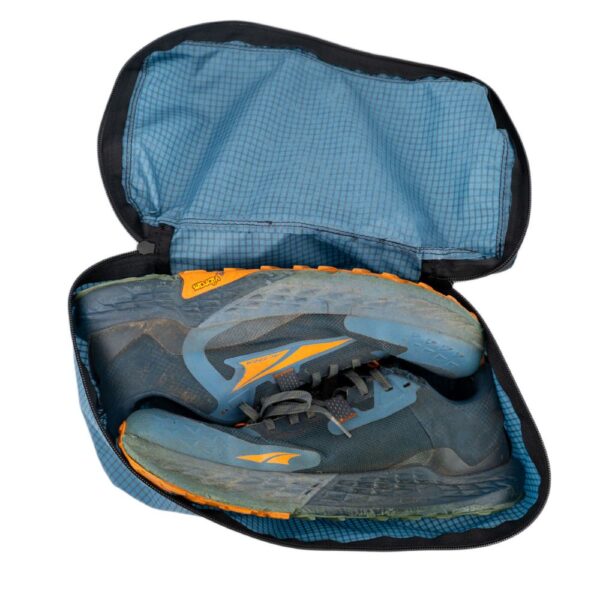 ULA Shoe Packing Cube in Smoke Blue containing a pair of hiking shoes.