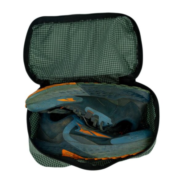ULA Shoe Packing Cube in ULA Green containing a pair of hiking shoes.