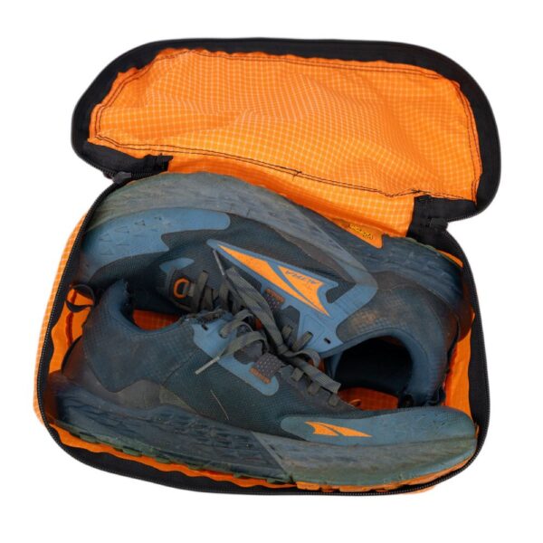 ULA Shoe Packing Cube in Tangerine containing a pair of hiking shoes.