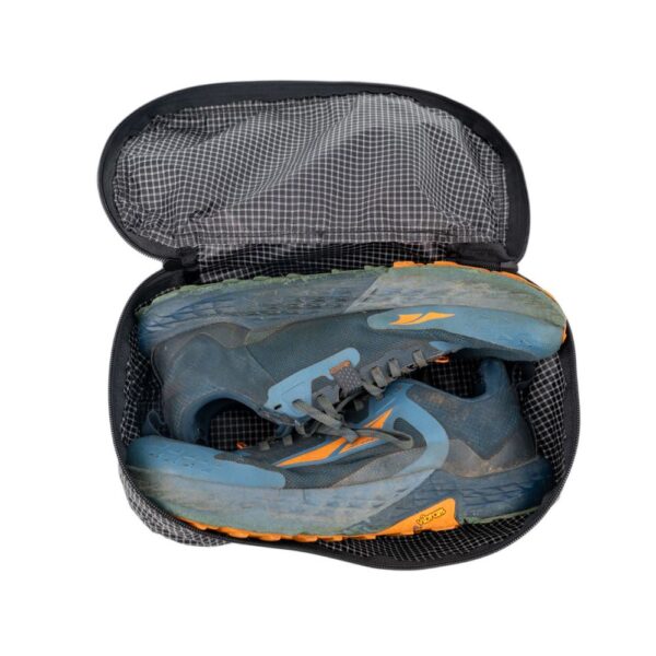 ULA Shoe Packing Cube in Black Beauty containing a pair of hiking shoes.