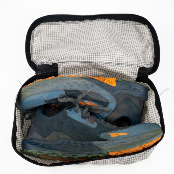 ULA Shoe Packing Cube in Silverado containing a pair of hiking shoes.
