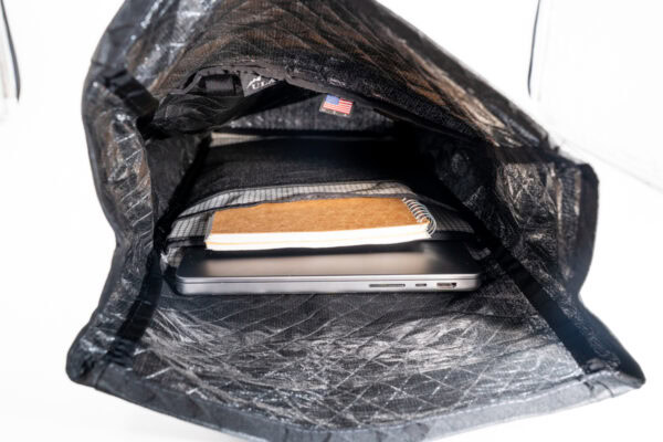 Interior sleeve of the ULA Ultra Node daypack, showing the padded, static laptop sleeve, main sleeve, mesh sleeve, and the main compartment.