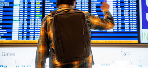 A man checks the departures board while wearing an ULTRA Cicada