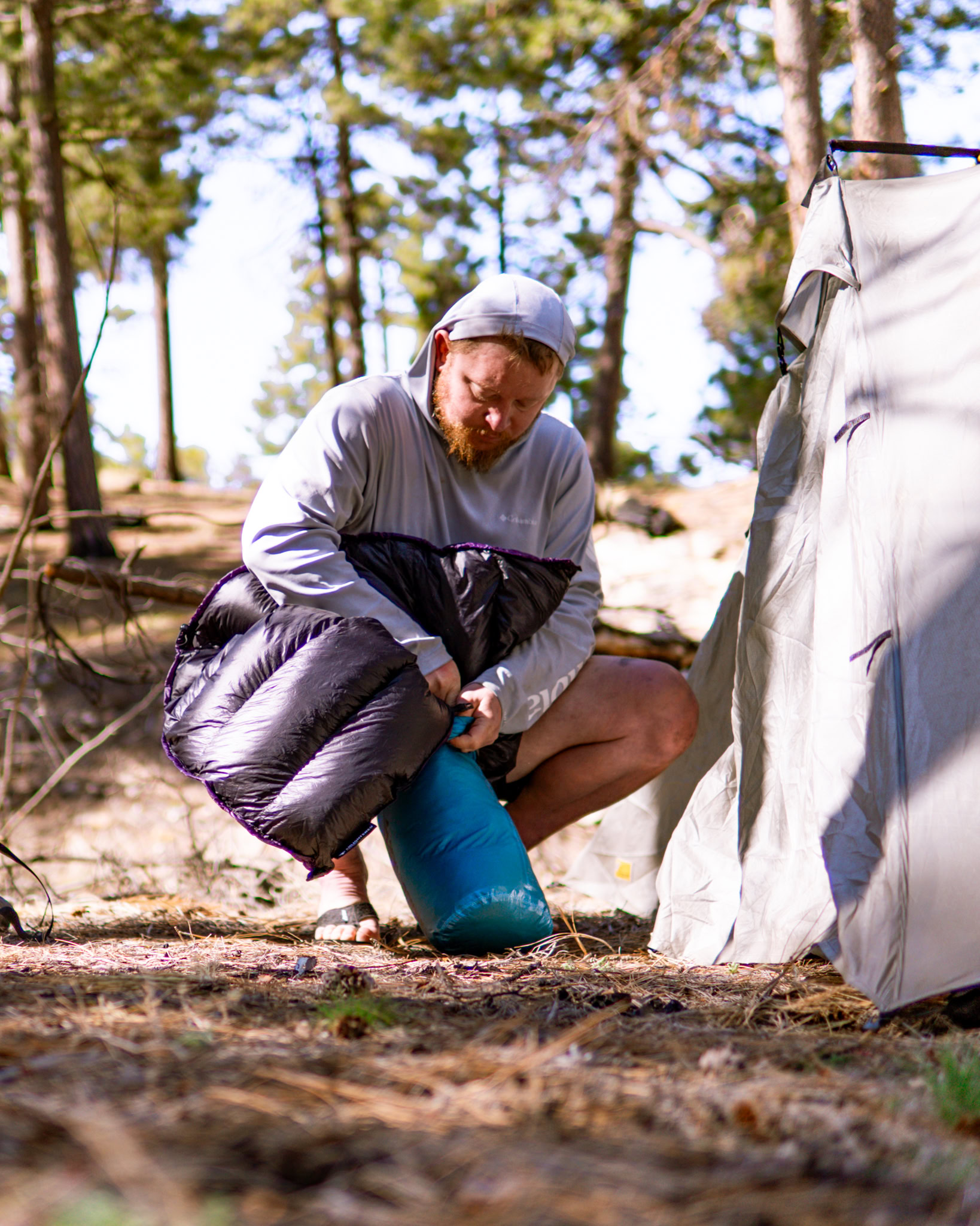 A man packs his sleeping bag